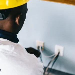 Electrician wiring a wall plug point
